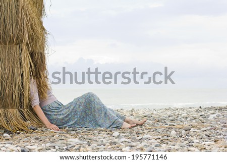 The beautiful blonde with curly hair on holiday by the sea