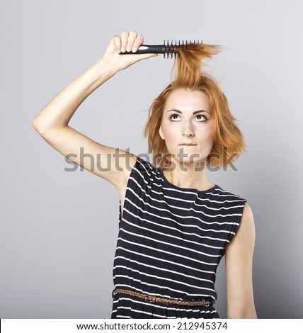 skinny redhead girl brushing her hair.Woman hair style fashion portrait . isolated. close up female face.