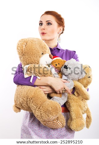 Young girl with a bunch of stuffed animals. Girl with soft toys on a white background