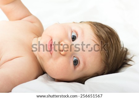 Beautiful baby.The child in the crib.baby on the bed.Portrait of a smiling child. A child on a white bed. Handsome boy.