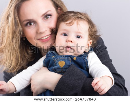 young mother with a little boy in her arms. Portrait of mother and son. Beautiful blonde. pectoral baby. happy family