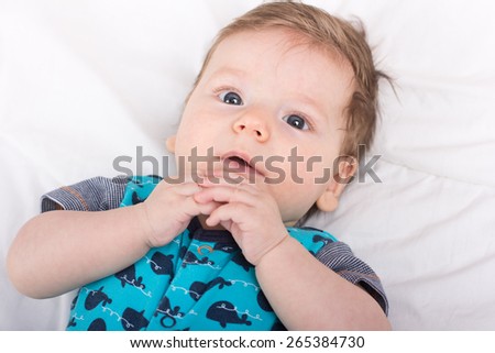 Beautiful baby.The child in the crib.baby on the bed.Portrait of a smiling child. A child on a white bed. Handsome boy.
