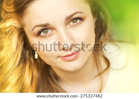 beautiful smiling girl relaxing on nature.Face of a beautiful young girl. Portrait outdoors.