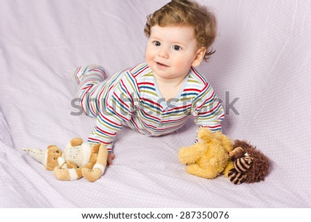 Portrait of a beautiful baby.Beautiful baby with lovely toys.The child in the crib