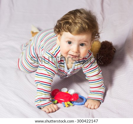 Beautiful baby with a lovely toys.The child in the crib