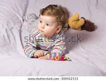 Beautiful baby with a lovely toys.The child in the crib