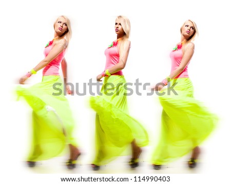 Cute young woman in bright clothes in motion on the white background