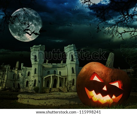 Bright carved orange pumpkin on Halloween against scary old castle in the moonlight