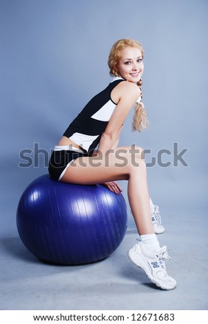 Woman go in for fitness with big blue ball