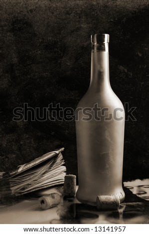 Bottle of wine on a table with age-old things, on a black background