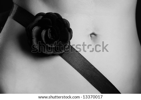 A strip with a black rose, it is wound around of a female stomach