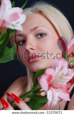 Pink flower of an orchid in hands of the young girl