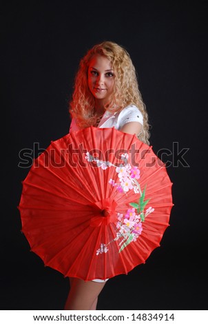 Portrait of young beauty woman in white dress at black background with umbrella