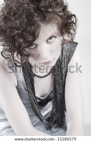 A portrait of young, beautiful, redheaded, ringleted  girl dressed in elegant clothes, with a sorrowful look