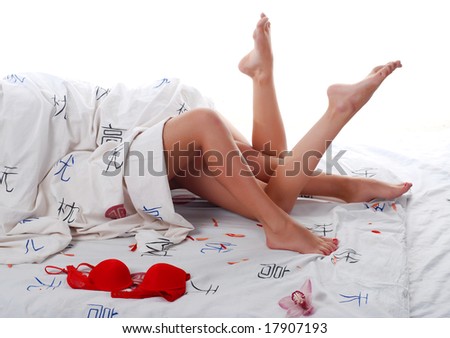 legs of two beautiful young woman in bed