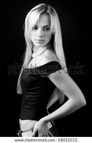 beautiful young woman in black top with pearl necklace