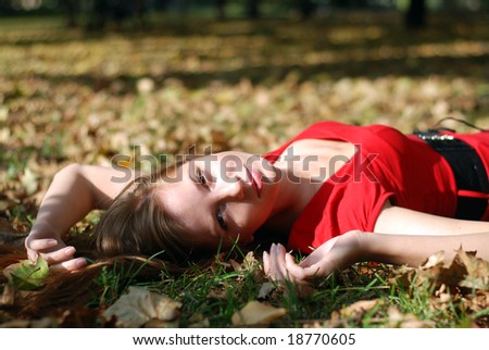 beautiful young woman lying on the maple leaf
