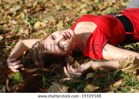 beautiful young woman lying on the maple leaf