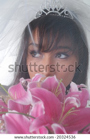 portrait of young dark-hair bride with bouquet of lilys