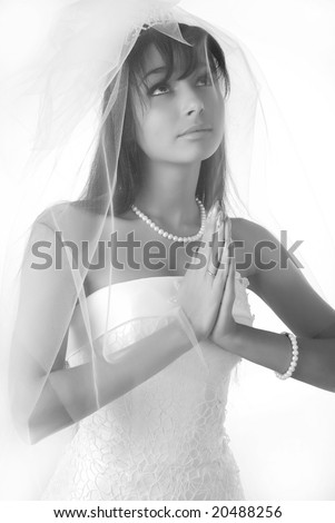 young beautiful young bride with dark hair is praying