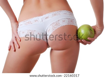 stock photo female buttocks in white panties and apple in hand