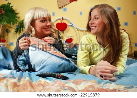 two beautiful women talking at the bedroom