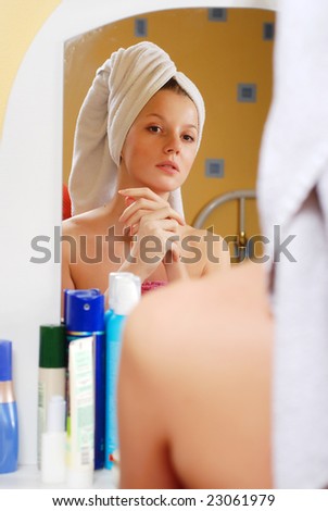 portrait of woman in towel near the mirror