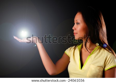 beautiful young woman witn sphere at black background