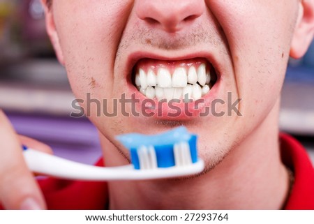 Man with toothbrush and opened mouth with white teeth