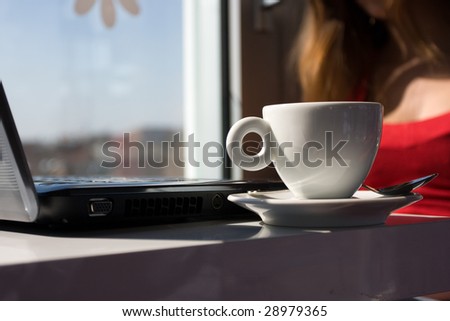 woman with laptop and cup of coffe