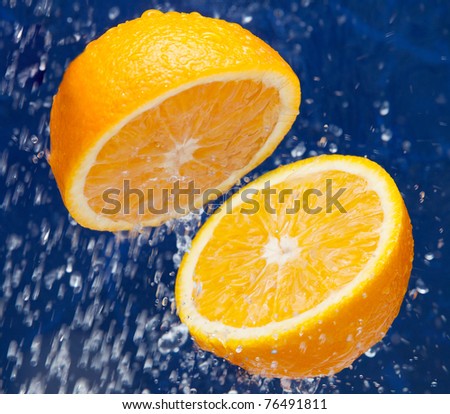 Fresh sweet orange under drops of water