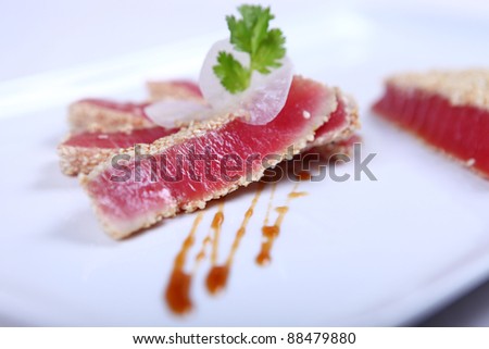 Fresh tuna meat sliced at white plate