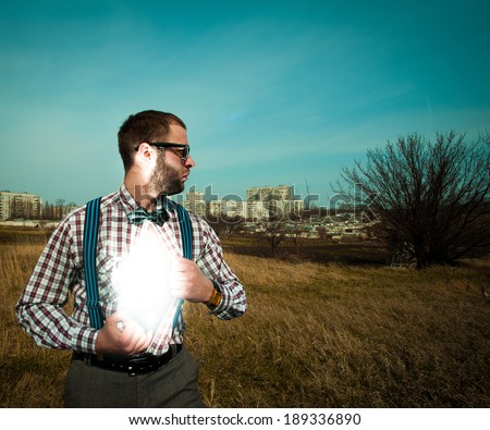 Nerd superhero with light under from his shirt