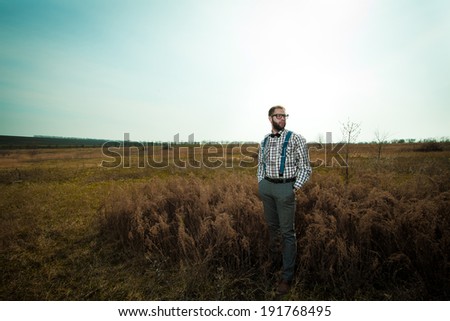 Redneck nerd man in glasses with beard outdoor