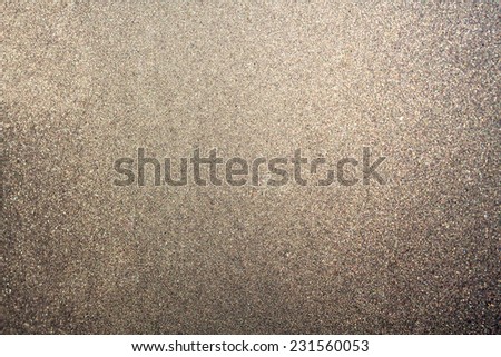 Abstract glittering platinum or brown dust or sand background with blur edges of image