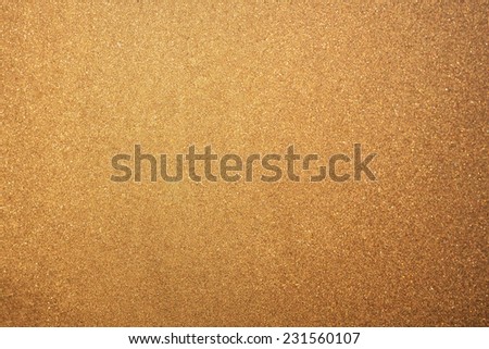 Abstract glittering golden or yellow dust or sand background with blur edges of image