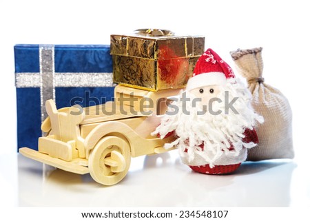 Santa Claus with old vintage wooden automobile, gift boxes and sack on white background with reflection. Main focus of image on Santa Claus