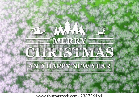 Merry Christmas and New Year greeting card with blurred frozen snowflakes on green colored winter background