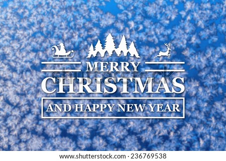 Merry Christmas and New Year greeting card on blurred winter blue colored background
