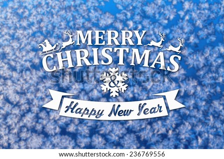 Merry Christmas and New Year greeting card on blurred winter blue colored background