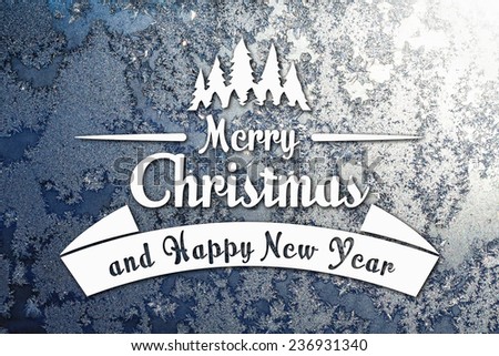 Merry Christmas and New Year greeting card on blurred frozen winter silver or gray colored background