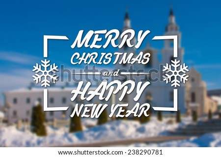 Merry Christmas and New Year greeting card on blurred white church at day and blue sky background