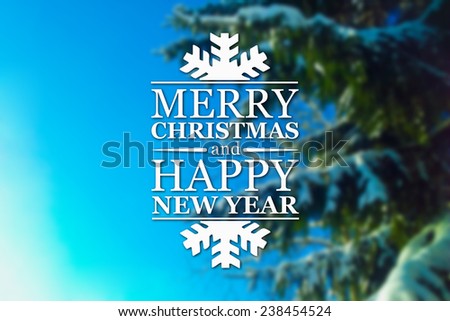 Merry Christmas and New Year greeting card on blurred spruce or fir-tree branches with snow on blue sky background