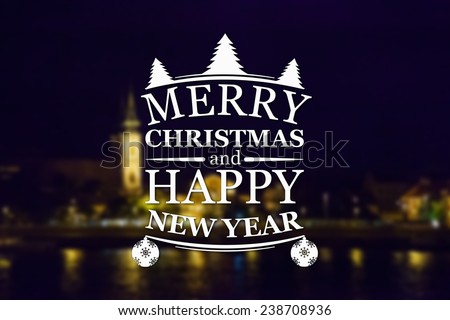 Merry Christmas and New Year greeting card on blurred night city illuminated old buildings with reflection in water background