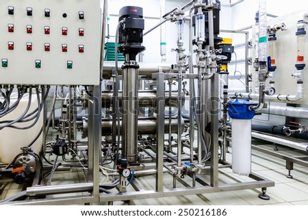 Pipes, pump and control panel in conditioning or distillation room on pharmaceutical industry or chemical plant