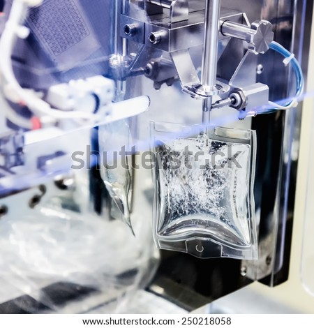 Machine filling liquid substance in transparent package on pharmaceutical industry manufacture or chemical plant