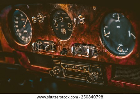 Dashboard in vintage interior of old automobile radio in dashboard in interior of old vintage automobile. Processed by vintage or retro effect filter