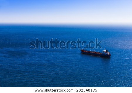Empty container cargo ship in the blue sea. Aerial view