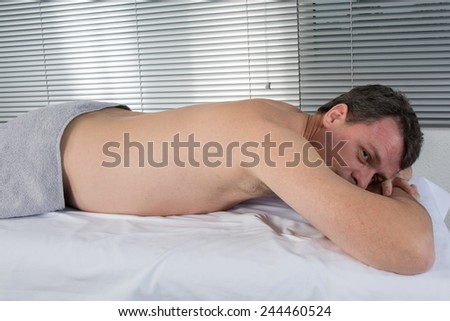 Man lying on the massage table waiting for a massage