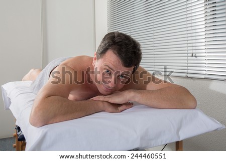 Man lying on the massage table waiting for a massage